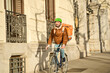 © Oscar - Courier bicycling through city delivering urban services