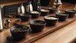 © Sergey - Professional coffee cupping table with elegant matte black tasting bowls filled with specialty coffees of different roast profiles, polished walnut