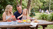 © Zireael - Family christmas picnic outdoors with parents and child sharing fruit and snacks for seasonal picnic banner and lifestyle background