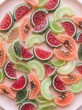 © mstsumaya - Assorted fruit shaped candies on a pink plate overhead view