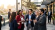 © Amonrat - A diverse group of people socializing at an outdoor event, engaged in conversation.
