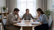 © Anwar - Unhappy couple with female mediator reviewing legal documents and signing divorce papers during family mediation session