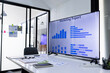 © SOMKID - A modern meeting room featuring a large digital screen displaying financial charts, sales opportunity scores, revenue, and profit analytics on the table in the foreground.