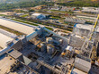 © DSMT - Industrial site with buildings and structures spread across an area with roads in the background during daylight