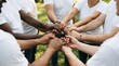 © MDAMANULLAH - Diverse team collaboration hands united in a circle representing unity and support outdoors
