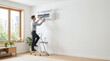 © Islam - Technician performing maintenance on air conditioning unit indoors