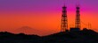 © spyrakot - Communication towers with service crew at sunset in remote mountainous landscape