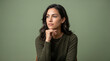 © Mharunismail234 - Thoughtful Young Woman Posing with Chin on Hand in Professional Studio Portrait
