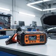 © lililia - Portable jump starter on a workshop bench for emergency vehicle battery support, roadside assistance, automotive equipment, travel safety.
