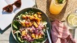 © fivan - A casual summer lunch scene featuring grilled peach salad beside sunglasses, a notebook, and lemonade
