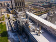 © DSMT - Large industrial site with pipes and structures seen from above in a busy area during the day
