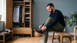 © Felippe Lopes - Man tying shoelaces on a wooden bench in front of an open wardrobe with clothes and shoes