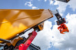 © NastyaPhoto - Telehandler telescopic boom arm with hydraulic lift cylinder. Modern construction machinery yellow crane mechanism section against sky background with industrial heavy duty vehicle details.