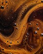 © Den - Close up surface of freshly brewed black coffee showing dynamic foam pattern