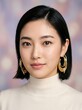© yeremikonovanda - Close-up portrait of a confident young Asian woman with short black hair and elegant gold hoop earrings