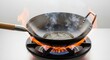 © Dini - Wok cooking with flames and steam on gas stove, close up, kitchen preparation