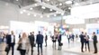 © CuteBee - Blurred business professionals walking through modern convention center exhibition hall during busy corporate trade show event with bright ambient lighting and blurred expo booths