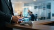© Zahid - Man making mobile payment using smartphone with contactless terminal modern pay via contactless