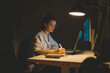 © yossarian6 - Businesswoman working overtime from home office