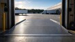 © Seentyr Str - Empty loading dock bay looking out at a distribution center yard with parked semi trailers.