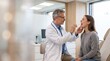 © Ievgeniia - Male doctor in white coat uses tongue depressor to examine young woman’s throat in modern clinic; both seated, patient mouth open during checkup