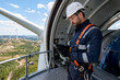 © FAHM Studio - Male Wind Turbine Technician Tablet Safety Harness Nacelle Wind Farm