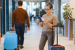 © Serhii - Senior woman checking travel documents at airport terminal