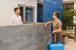 © Serhii - Guest checking in at modern hotel reception desk