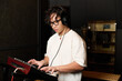 © LIGHTFIELD STUDIOS - Creative young man crafting music in a recording studio setting
