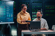 © Zamrznuti tonovi - Two diverse it engineers collaborating in a modern data center, managing complex systems, network security, and real time analytics