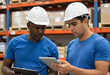 © Pixel-Shot - Two warehouse workers checking inventory with tablet and clipboard