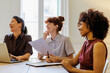 © BONNINSTUDIO/Stocksy - Female professionals collaborating and smiling during office meeting