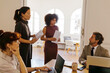 © BONNINSTUDIO/Stocksy - Business professionals working together during a meeting