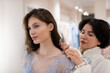 © Niyaz Tavkaev/Stocksy - Charming woman trying on tailor made dress with female assistant