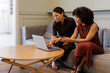© BONNINSTUDIO/Stocksy - Women collaborating on laptop together at lounge area