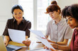 © BONNINSTUDIO/Stocksy - Group of female professionals collaborating on business documents