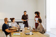© BONNINSTUDIO/Stocksy - Business professionals working together during meeting at office