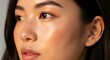 © BackgroundStudio - A close-up portrait of a young Asian woman featuring glowing skin and subtle makeup.
