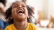 © Nadezhda - A joyful young African American girl with curly hair laughs heartily with her eyes closed, radiating pure happiness in bright, natural light.