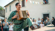 © Muhammad - Happy musician playing traditional accordion during outdoor community celebration with blurred crowd background with historical clothing performing
