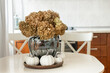 © svetlana_cherruty - Dried hydrangea bouquet with white pumpkins on dining table autumn home decor
