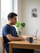 © Naret - Asynchronous communication work from home focus man using tablet at desk in bright room