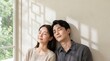 © ANUPONG WANSUKH - Peaceful Young Asian Couple Relaxing with Eyes Closed in Warm Sunlight at Home