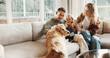 © peopleimages.com - Parents, baby and dog with smile on couch for care, play and love for bonding or connection in home. Father, mother and child in living room for pet animal, stroke and relax on sofa at family house