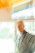 © Tetra Images - Man against window, motion blur