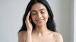 © Max_T - Closeup portrait of a beautiful young indian woman with glowing skin, eyes closed, touching her temple, feeling relaxed and peaceful, skincare and beauty concept