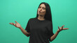 © Krakenimages.com - Woman presenting with open hands and expressive face in a green screen studio, palms up and shrugging gesture to camera; curiosity.