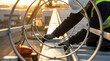 © Chopang.studio - Worker inspecting metal roof flashing at sunset, wearing safety helmet and gloves, focused on construction task with circular metal safety guard in foreground, industrial site background