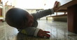 © Marco - Baby boy on kitchen floor discovering the world