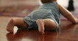 © Marco - Back of little baby infant on hardwood floor at home